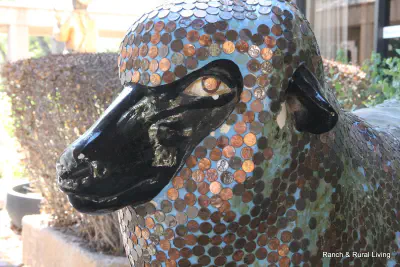 A San Angelo sheep statue decorated with pennies, located at Wells Fargo Bank downtown.